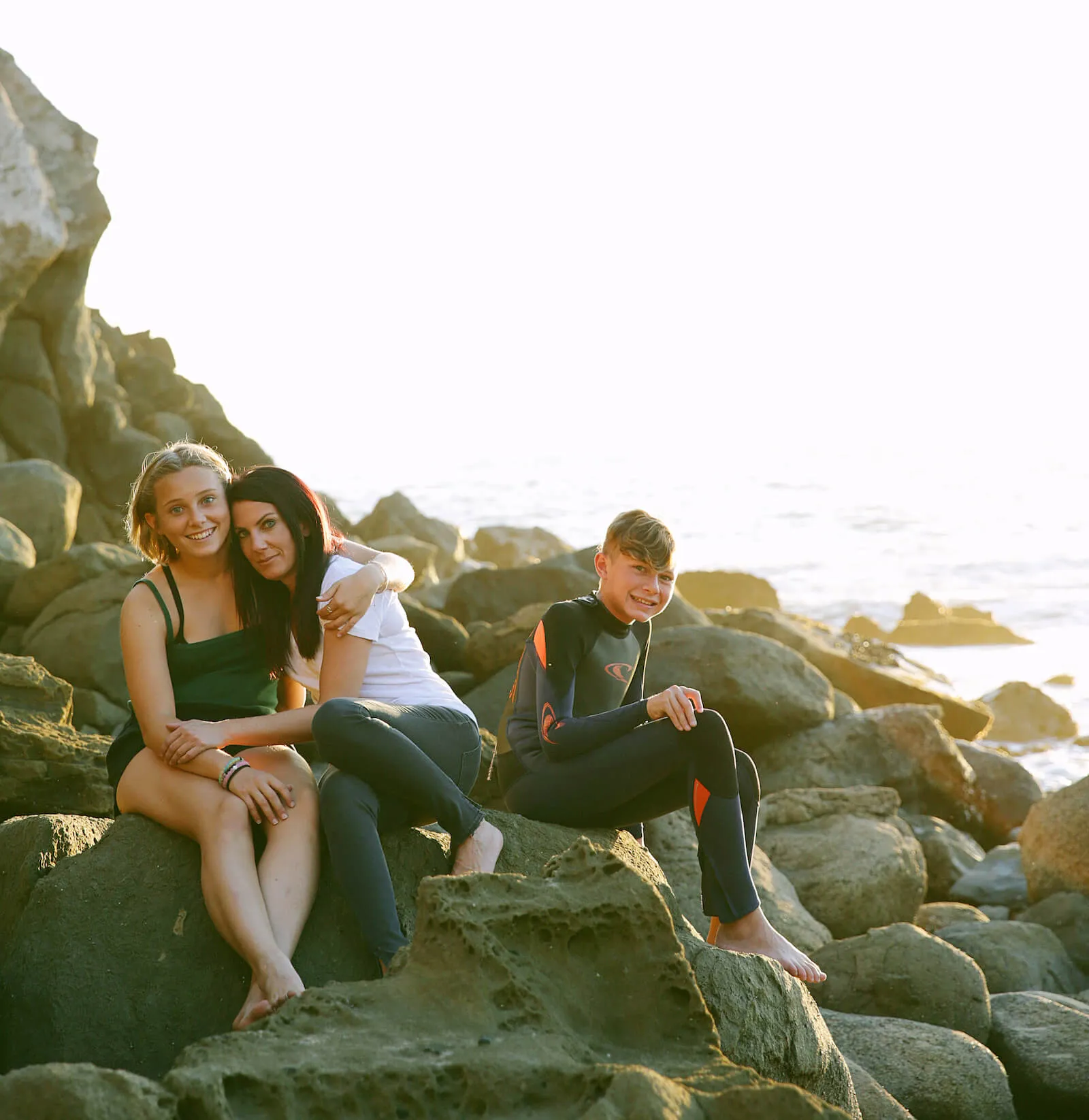 Michele and family on the rocks by the beach